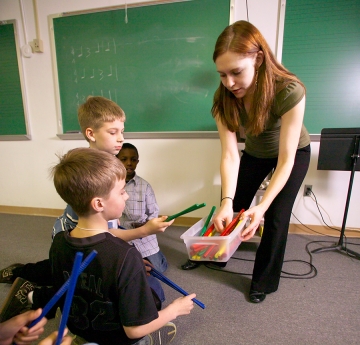 Student teaching music to elementary students